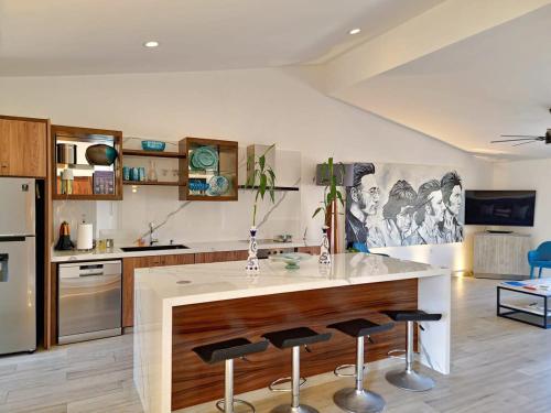 a kitchen with a large island with bar stools at Unit 216-Casa Ricardo-Ocean View RENOVATED in Cabo San Lucas