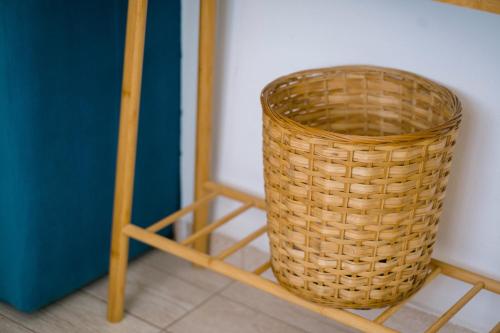 a wicker basket sitting next to a wooden stool at The Rooftop of Apartments Lungo Mare in Ulcinj