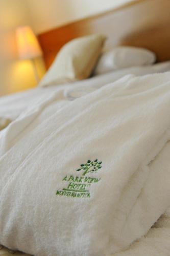 a close up of a white blanket on a bed at A Park View Hotel in Wolverhampton