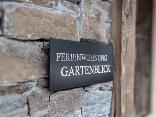 a sign on the side of a stone wall at Farmhouse in Schwendau near Ski Zillertal in Hippach