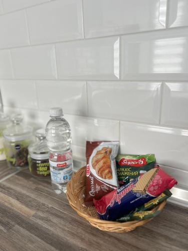 a basket filled with food and a bottle of water at Sisters apartment Shevchenko in Chernihiv