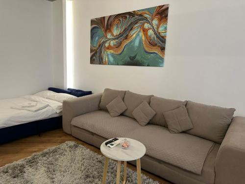 a living room with a couch and a table at D&E Apart in Bucharest