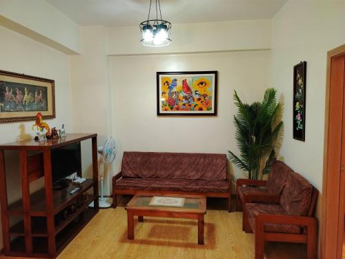 a living room with a couch and a table at Cedar Peak Baguio Staycation in Baguio