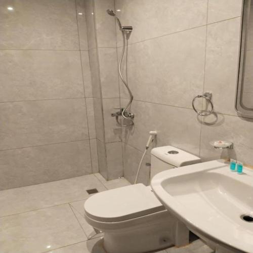 a bathroom with a shower and a toilet and a sink at Etlalat Obhur in Jeddah