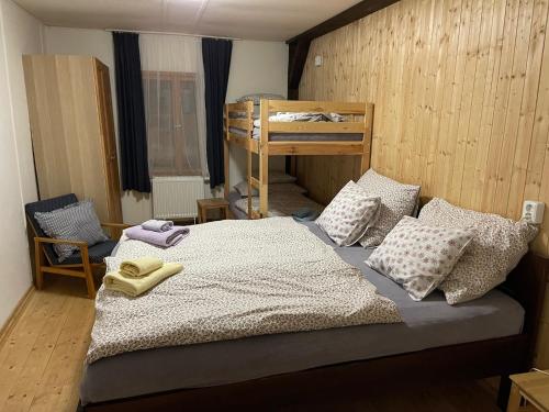 a bedroom with a bed with two bunk beds at Chata Betty Kvilda in Kvilda