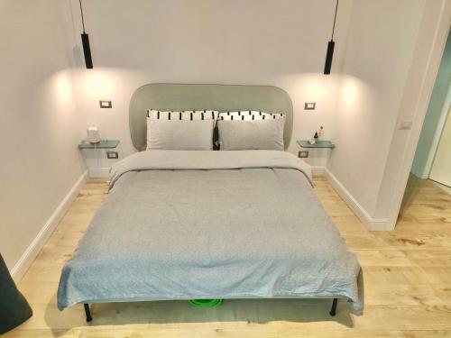 a bedroom with a large bed with two tables at Venezia Home in Rovereto