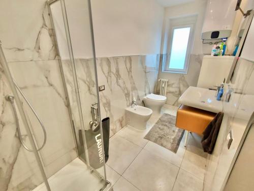 a bathroom with a shower and a sink and a toilet at Venezia Home in Rovereto