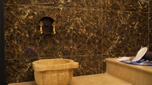 a bathroom with a toilet and a wall at Cip Hotel & Spa - İstanbul Bakırköy City Center in Istanbul