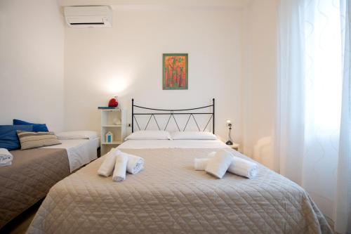 a bedroom with two beds with towels on them at Frog 30 in Gabicce Mare