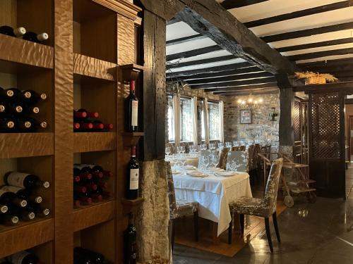 a dining room with a table and some bottles of wine at Hotel Don Pablo in Villasana de Mena
