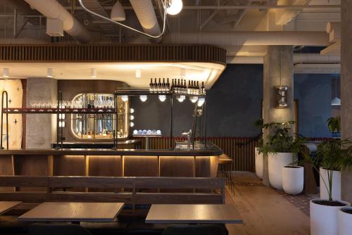 a restaurant with wooden benches and a bar at Drifter Christchurch in Christchurch
