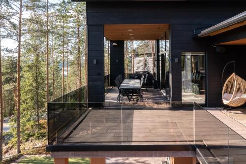 a black house with glass doors and a patio at Villa FeelGood Himos in Himos