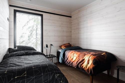 a bedroom with two beds and a window at Villa FeelGood Himos in Himos
