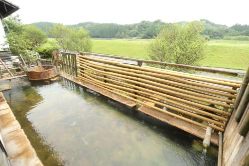 a wooden fence over a body of water at 旅館早水荘 in Yunoo