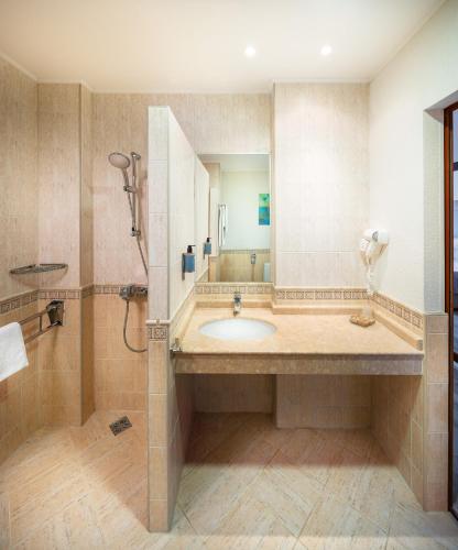 a bathroom with a sink and a shower at Alua Helios Bay - All Inclusive in Obzor