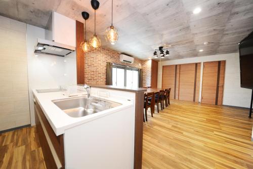 a kitchen with a sink and a table with chairs at Shinjuku NY House 301 in Tokyo