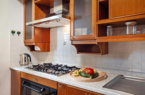a kitchen with a bowl of fruit on a cutting board at House Olive Garden Strunjan in Strunjan