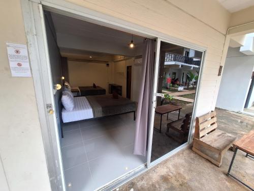 a view of a bedroom from the balcony of a house at Sleep Pai Bed & Breakfast in Pai