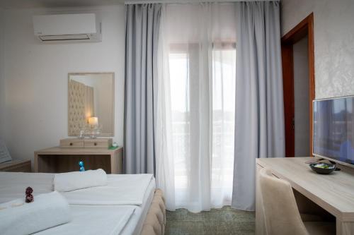 a living room with a white couch and a window at Villa Pasis in Rovinj