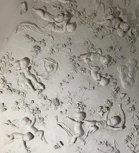 a black and white drawing of babies on a wall at Caruso Place Boutique & Wellness Suites in Naples