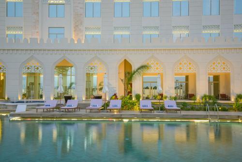 a hotel with a pool in front of a building at Golden Tulip Zanzibar Airport Hotel & Spa in Zanzibar City