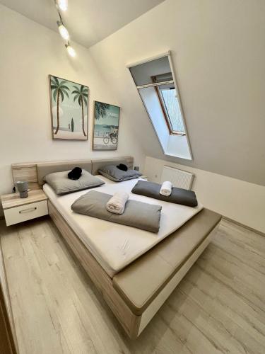 a bedroom with two beds and a window at Móló Resort 25 by HelloBalatonlelle in Balatonlelle