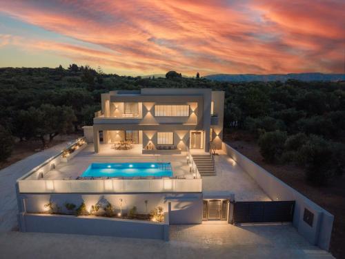a villa with a swimming pool at sunset at Villa Frantzeska - Elegant Villa close to Tsilivi, by ZanteWize in Tsilivi