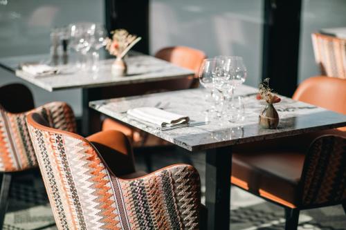 a group of tables with wine glasses on them at Hotell Lappland in Lycksele