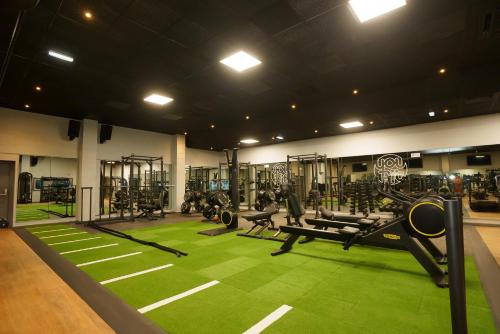 a gym with lots of equipment on a green carpet at Park hall Hotel & Spa Lancashire, a member of Radisson Individuals in Eccleston