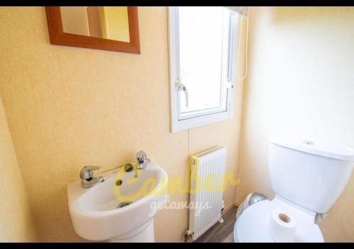 a bathroom with a toilet and a bidet at MP503 - Camber Sands Holiday Park - Sleeps 8 - Large Gated Decking - Amazing views in Camber