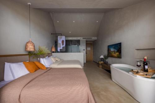 a bedroom with a large bed and a bath tub at QiPan Holiday hotel Lugu Lake in Ninglang