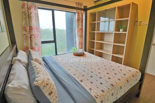 a bedroom with a bed with a window at Nature Home - Swiss Garden Resort Residences in Kuantan