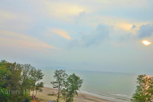 a view of the beach with a cloudy sky at Nature Home - Swiss Garden Resort Residences in Kuantan