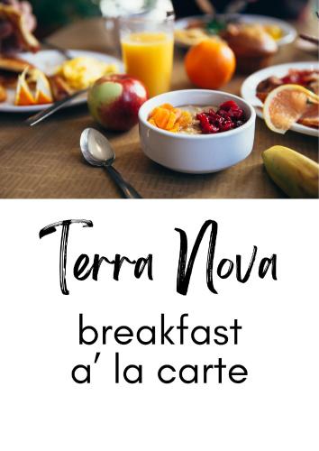 a table with a bowl of fruit and a plate of food at Terra Nova Luxury Villa in Mystras