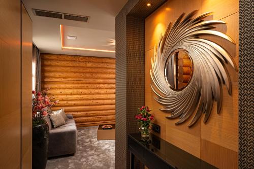a living room with a mirror and a couch at Avalon Resort & SPA in Miskolctapolca