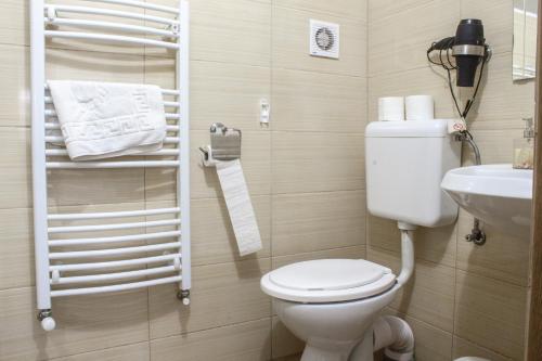 a small bathroom with a toilet and a sink at Air&Day in Vecsés