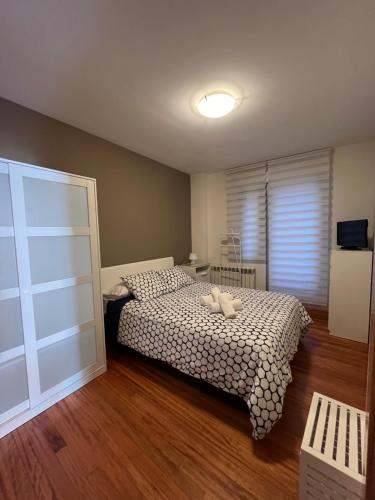 a bedroom with a bed with a stuffed animal on it at Piso en la ruta del Románico in Zamora