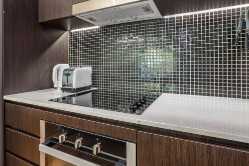 a kitchen with a sink and a counter top at Stones Corner Vista Stay in Brisbane