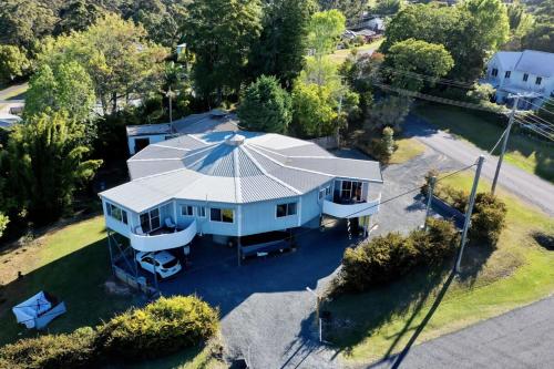 an overhead view of a white house with a large roof at Family & Friends Escape Tamborine Mountain in Mount Tamborine