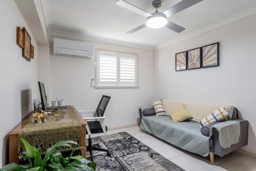 a living room with a bed and a couch at Seaside Serenity at Plumeria Place in Brisbane