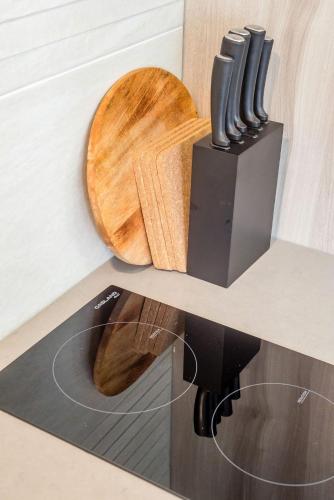 a cutting board and a knife block on a counter at Seaside Serenity at Plumeria Place in Brisbane