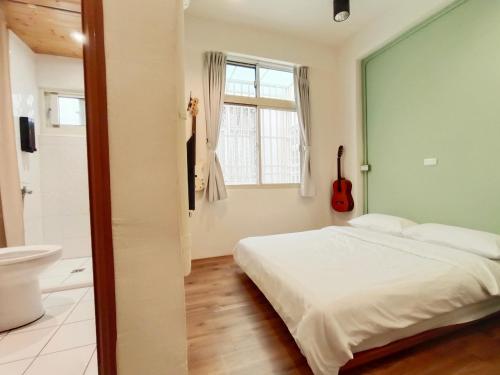 Postel nebo postele na pokoji v ubytování 東海小時光 Tong Hai Time Homestay