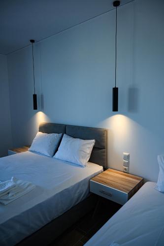 a bedroom with two beds and a blue light at Costa Varda Apartments in Mourteri