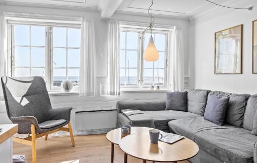 a living room with a couch and a table at Awesome Apartment In Svaneke With Wifi in Svaneke