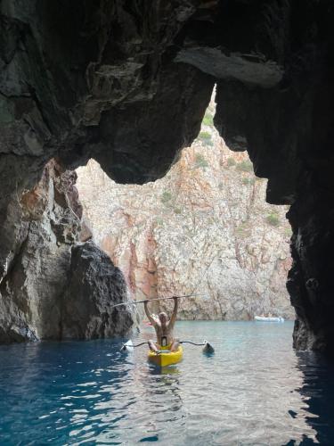 a person in a kayak in a cave at Casa Tartaruga in SantʼAntìoco