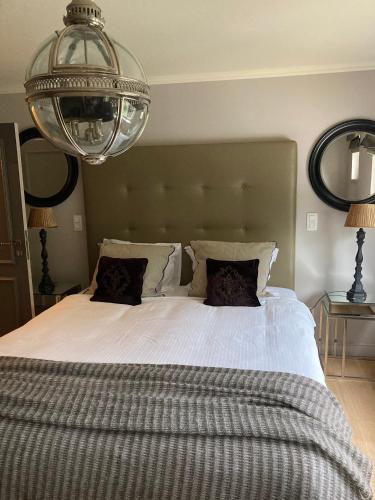 a bedroom with a large bed with a large headboard at Villa Reynaert in Opoeteren
