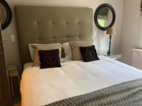 a bedroom with a large bed with two pillows at Villa Reynaert in Opoeteren