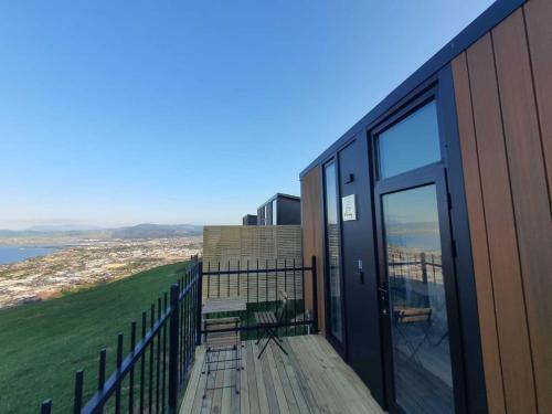 a balcony of a building with a view of the ocean at Aorangi Peak Cabins 3 by Tiny Away in Rotorua