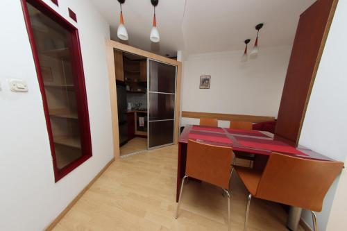 a kitchen and dining room with a table and chairs at Skopje Plaza Apartment in Skopje