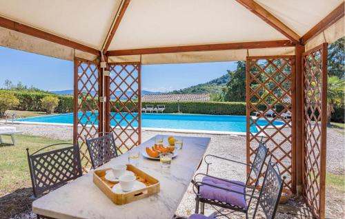 a gazebo with a table and chairs and a pool at Cozy Home In Orvieto With Wifi in Orvieto